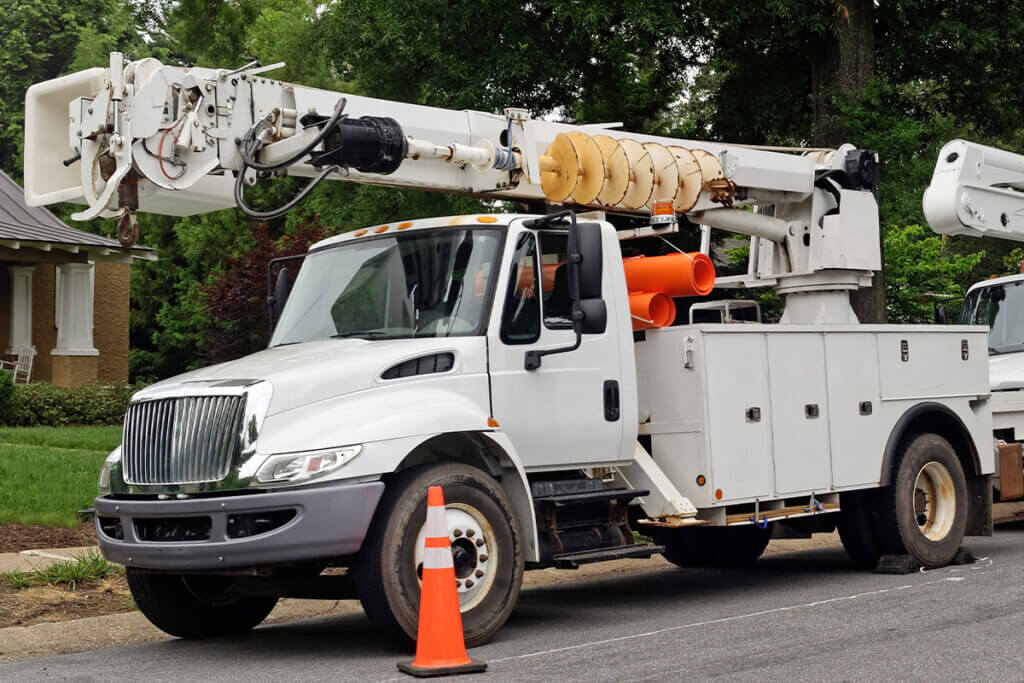 Utility trucks parked near cones